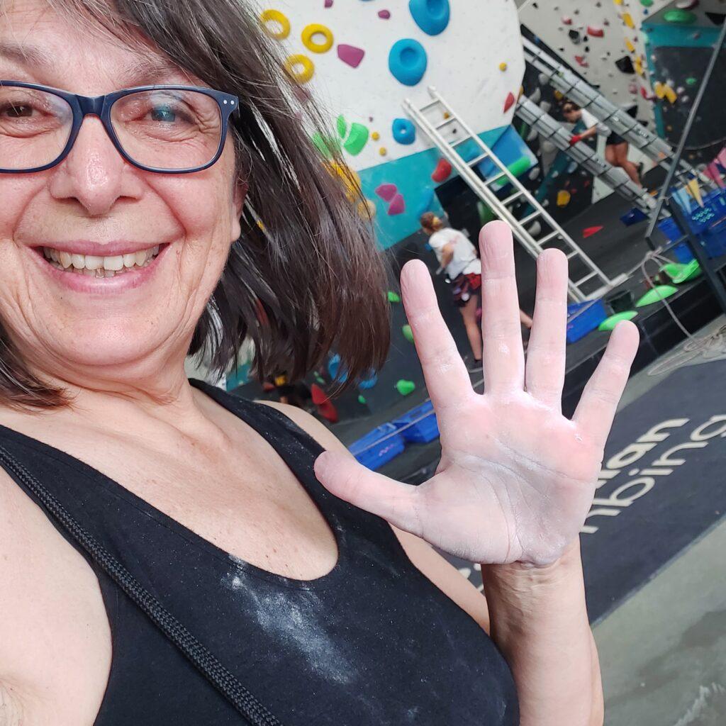 Trisha Lewis at Parthian Indoor Climbing Wall shwoing chalky hands